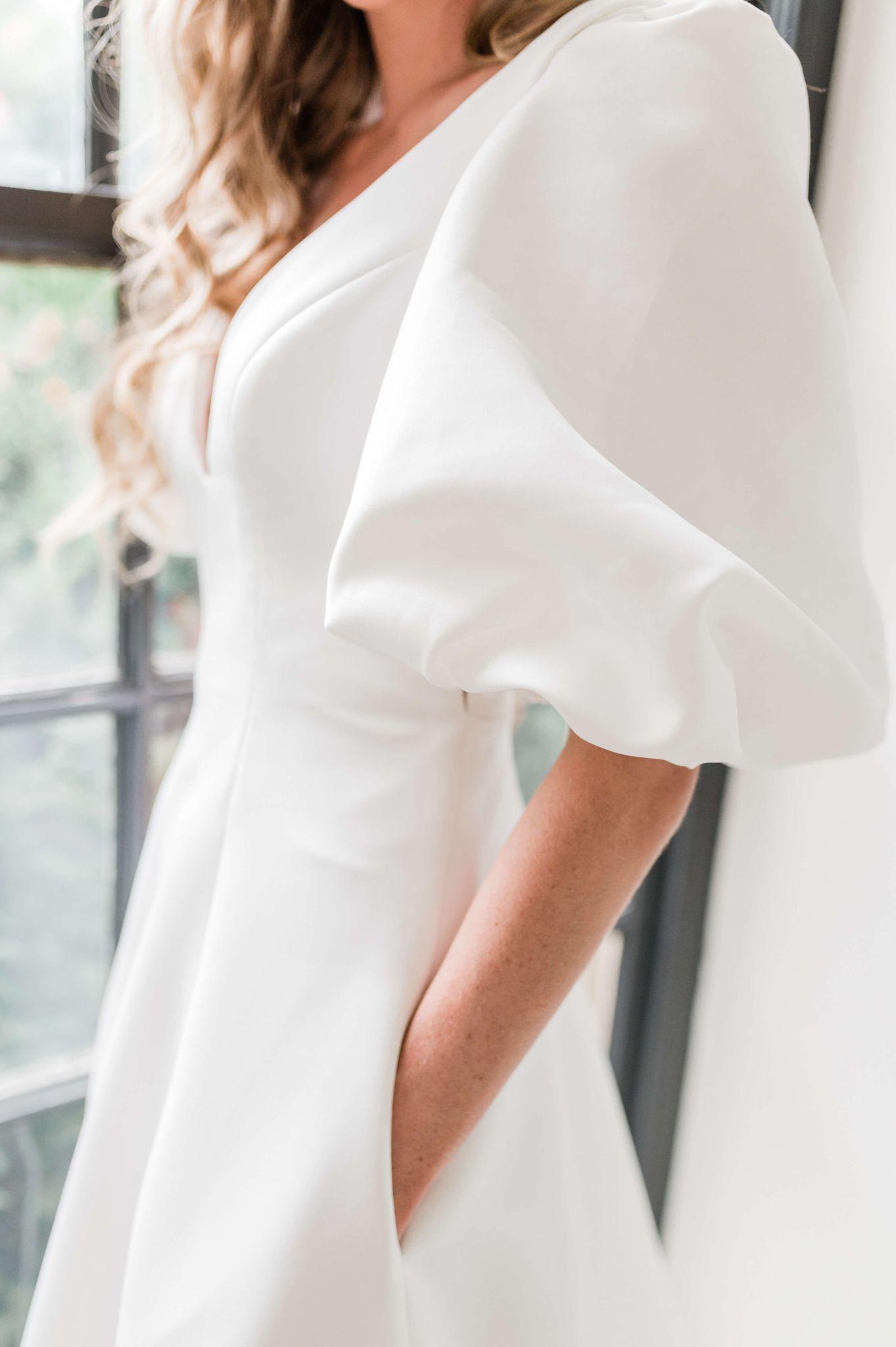 a winter friendly white dress with puffed sleeves from Versailles Atelier Bridal