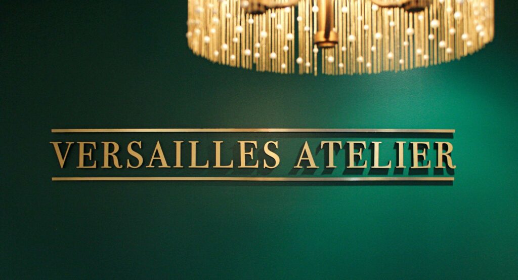 versailles atelier signage against the jade green wall