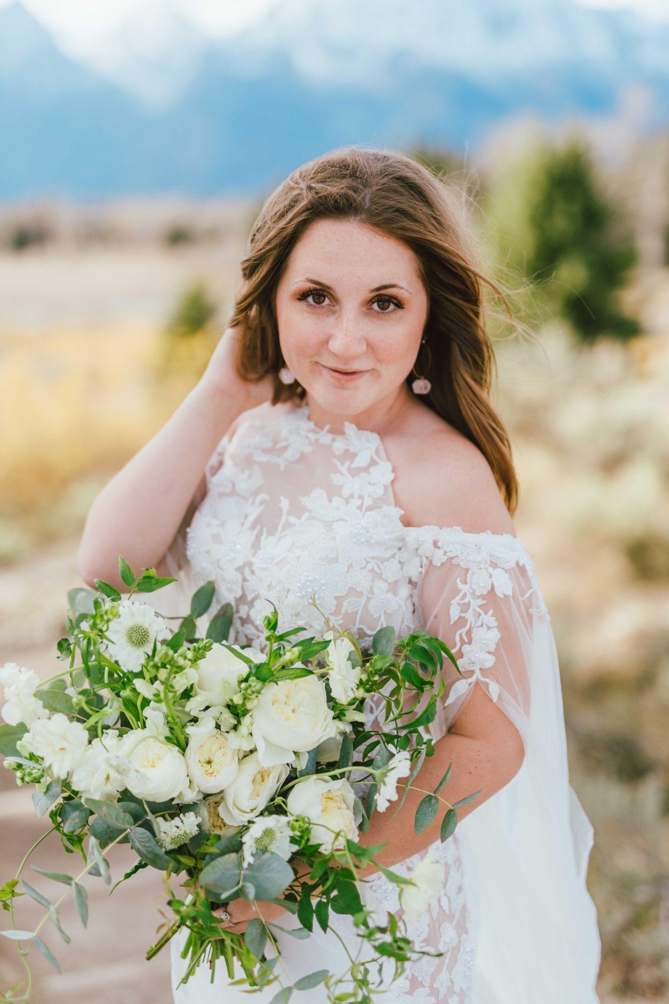 professional photo of a bride in her wedding gown while holding a bouquet of flowers