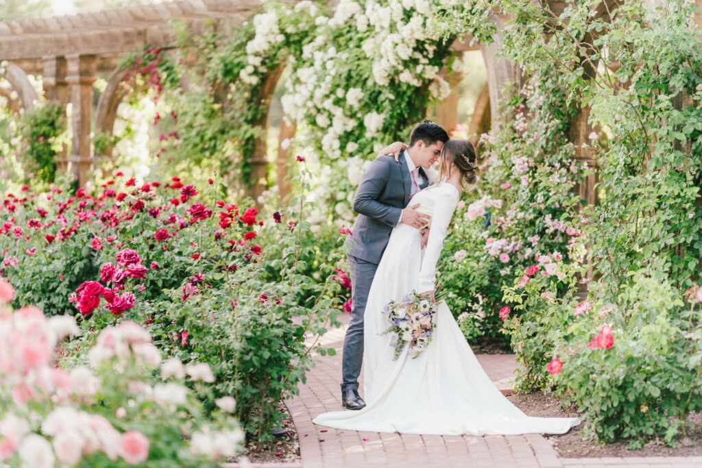 photo of a bride and groom at a garden filled with flowers