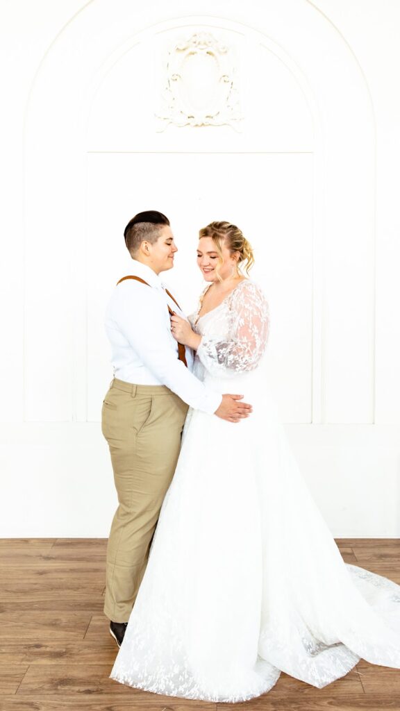 a bride and groom posing lovingly in their wedding gown and suit