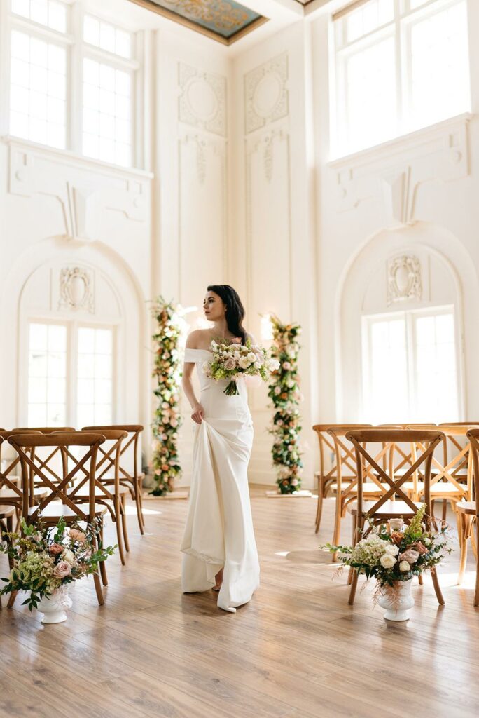 image of a bride in her wedding gown while holding a bouquet