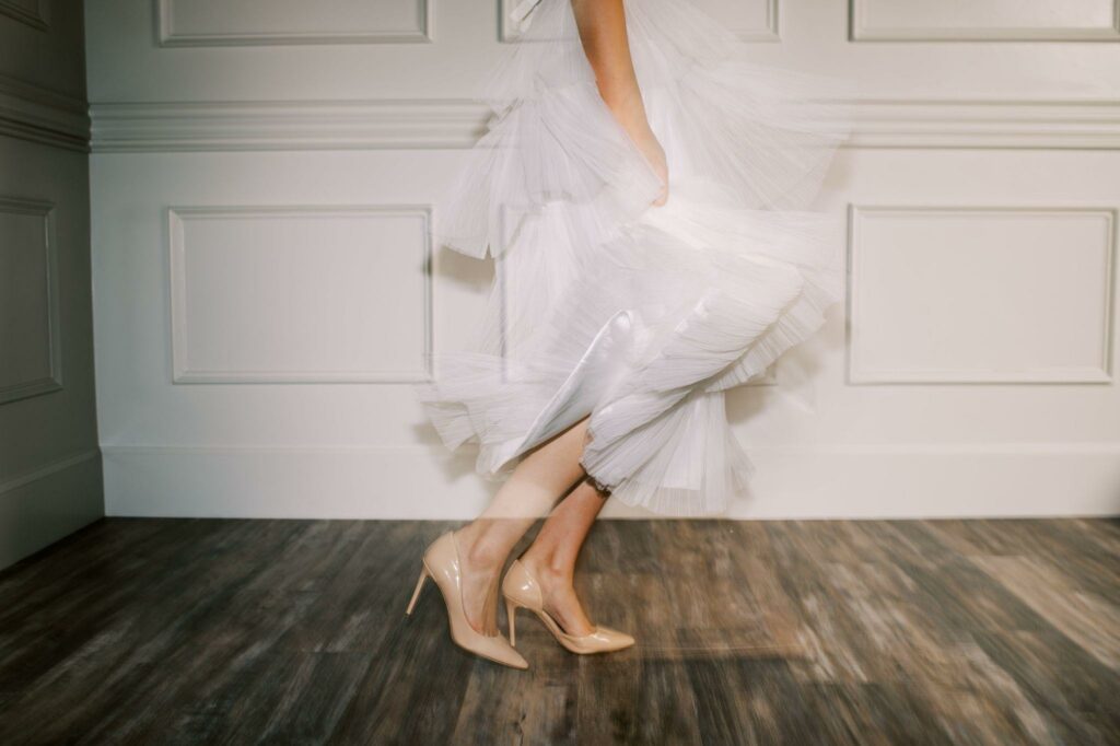 a blurry image of a woman wearing tea-length wedding dress