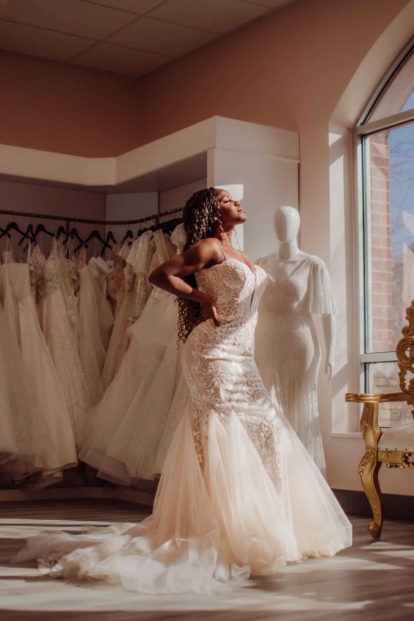 a beautiful woman posing while basking in the sunlight in a wedding dress