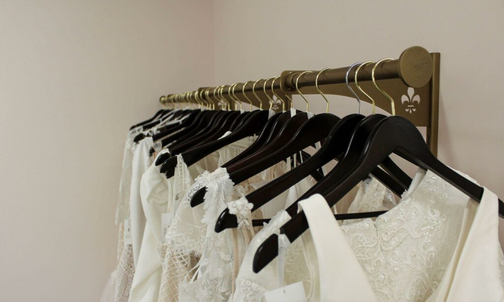 a close-up shot of wedding gowns in hangers