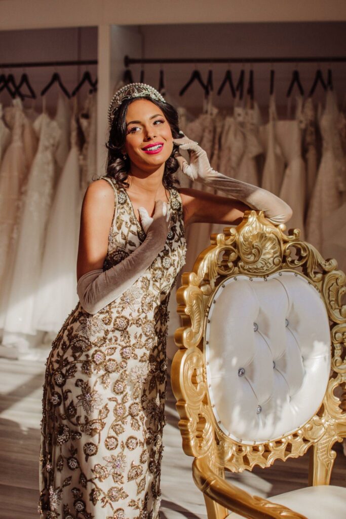 a woman leaning on the elegant chair inside a bridal boutique