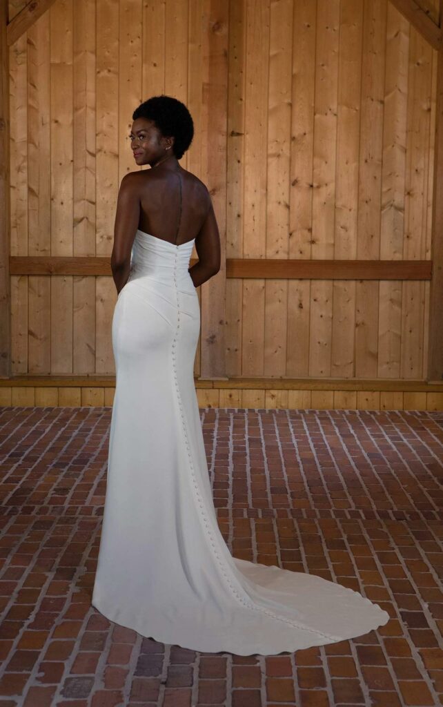 a bride wearing a fitted gown with flowy skirt