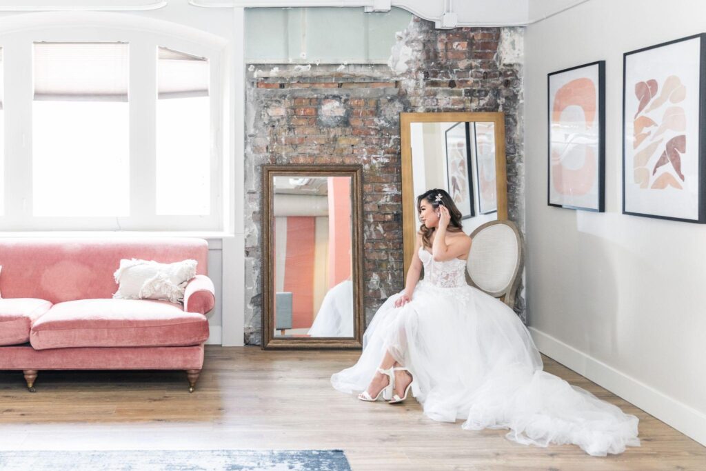 A bride in a serene room with pink furniture
