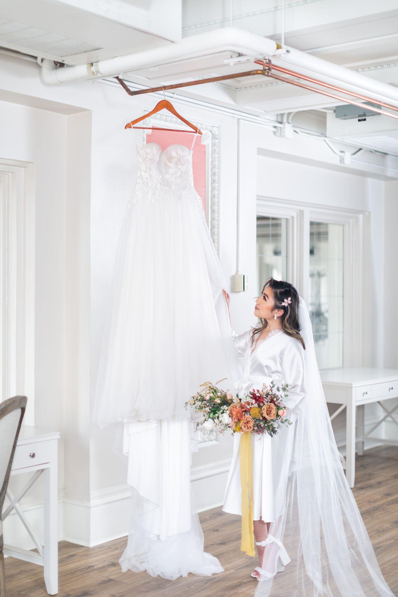 a bride holds her wedding dress